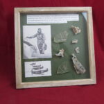 Large glass framed group of airframe, cockpit perspex and engine parts from RAF Spitfire R6753 piloted by Flight Officer D. Pinckney