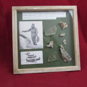 Large glass framed group of airframe, cockpit perspex and engine parts from RAF Spitfire R6753 piloted by Flight Officer D. Pinckney
