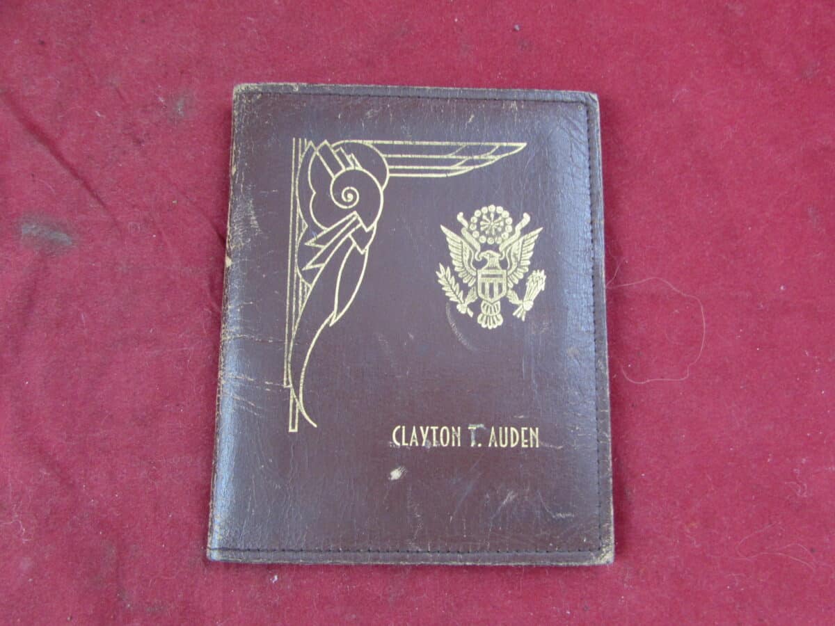 A WW2 US leather wallet which is named to a Clayton T. Auden, US Army