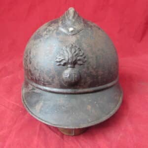 An original French Model 1915 “Adrian” infantry helmet , complete with liner and chinstrap, with its original RF (République Française) flaming grenade badge